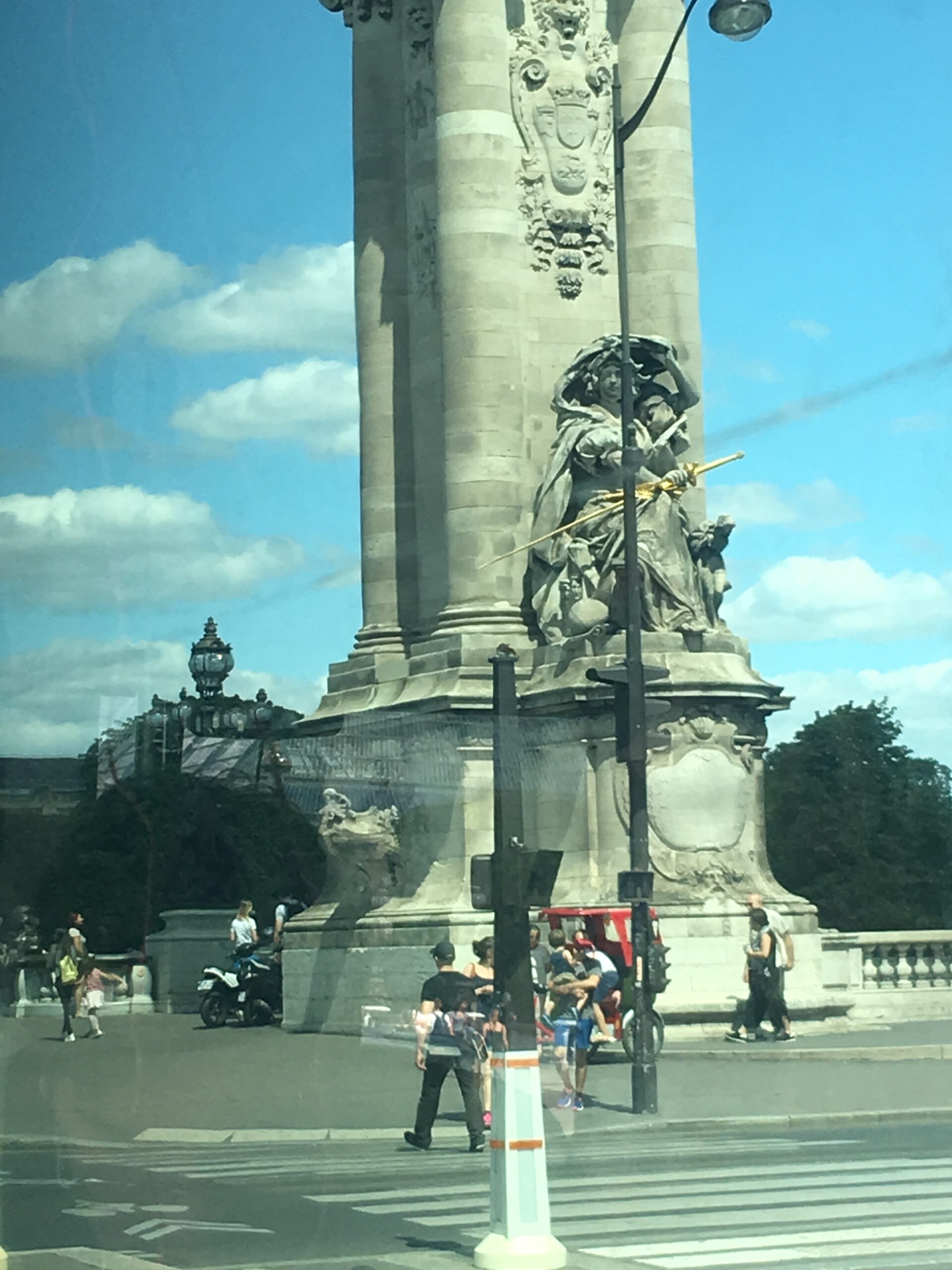 Statue of woman holding golden sword at Pont Alexandre III in Paris